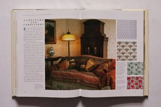 A picture essay on Furniture and Upholstery on pages 204-205 of The Victorian House Book opens with a colour photograph of a spacious drawing room decorated by Robin Guild, a richly upholstered sofa strewn with cushions in the centre.