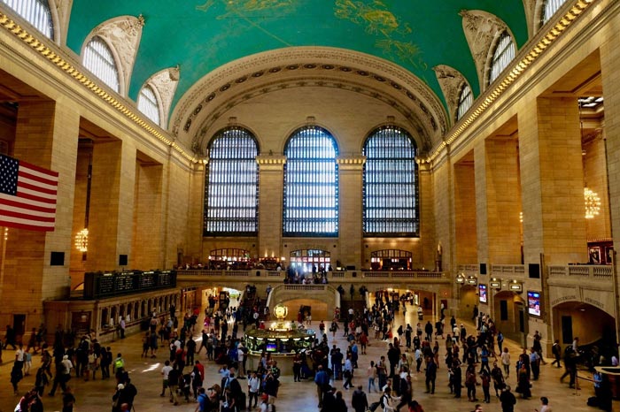 In this colour photograph taken by Ian Logan the magnificent concourse of New York’s Grand Central Terminal is brightly illuminated and thronged with passengers.