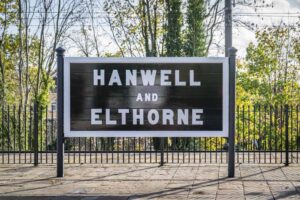 The black-and-white original sign for Hanwell station is large and boldly lettered. 
