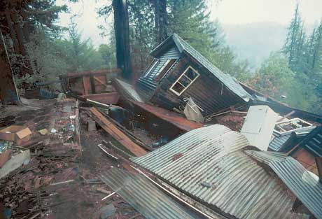 In a photograph taken by the US Geographical Survey a house destroyed by the Loma Prieta earthquake of 17th October 1989 keels over at a drunken angle.