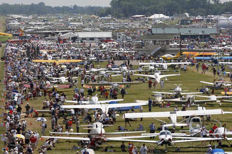 In this colour photograph visitors admire the thousands of light aircraft that have flown in for the annual EAA AirVenture show at Oshkosh, Wisconsin.