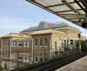 Colourful iron cresting tops the mansard roof of Peckham Rye station. 