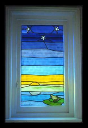 Stained-glass frog and stars.