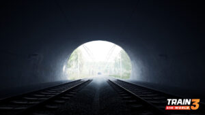 In this colour screenshot, two sets of tracks stretch forward towards the exit of a tunnel. The light at the tunnel’s mouth is blown out.
