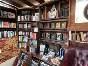Shelves in a Dutch barge are packed with books of all varieties.