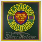 This enamelled metal plaque designed by Ian Logan features a green and yellow Seaboard Railroad logo on a dark green background.